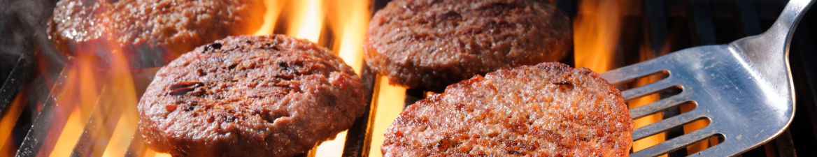 Hamburgers on the grill from AAA Royal Catering - Part of our All American Picnic and BBQ Menu